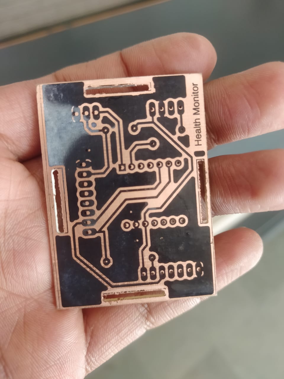 Fabricated prototype PCB held in hand